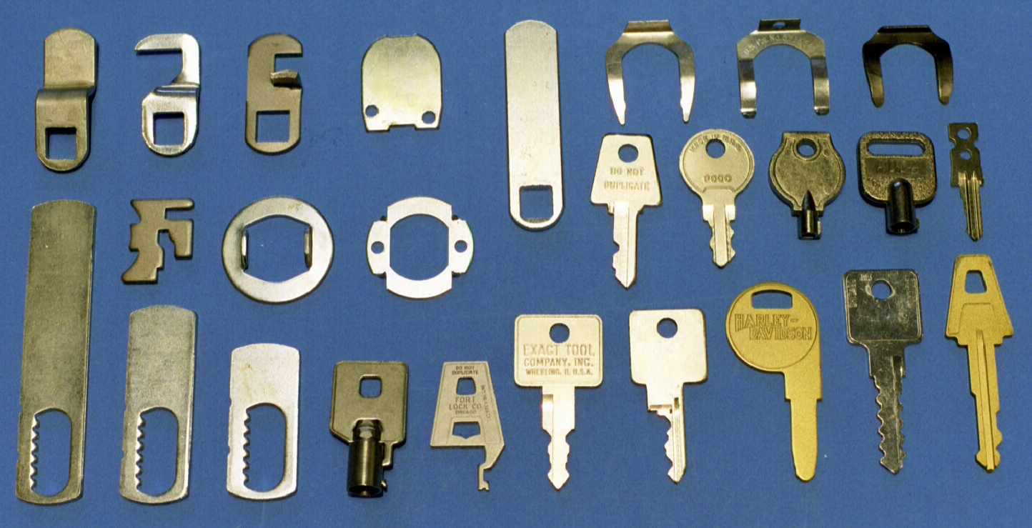 Metal stampings of lock components: Brass and steel keys, washers, cams, spring clips